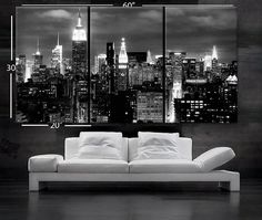 black and white cityscape with the empire building lit up at night in new york