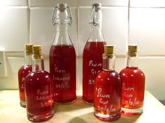 three bottles of rum in front of a white tile wall with words written on them