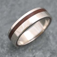 a wedding ring with two wood inlays