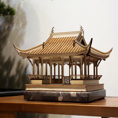 a model of a pagoda on top of a wooden table