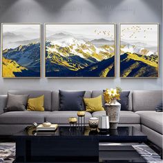 a living room with three paintings on the wall