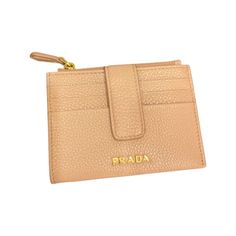 This light beige Prada wallet is an effortlessly chic way to store credit cards, coins, and small bills. This wallet's conveniently small size makes it easy to keep in your purse or pocket. The four exterior card slots makes organizing a breeze.    Model: 1MC026  Cipria Beige Leather    Gold Tone Hardware  Prada Milano Logo  Zipper Closure  Four Exterior Card Slots  Vitello Grain Pebbled Leather  Measurements: 4.5 x 0.75 x 3.5" (LWH)  Includes authenticity cards and Box  Made in Italy Prada Milano, Prada Wallet, Handbag Wallet, Zip Wallet, Wallet Accessories, Wallet Chain, Leather Chain, Store Credit Cards, Zip Top