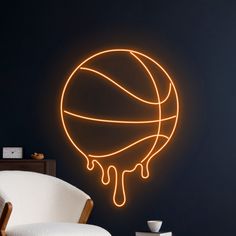 a basketball ball with dripping paint on it in a dark room next to a white chair