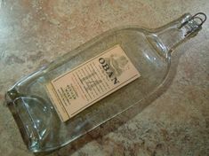 an empty glass bottle sitting on top of a table