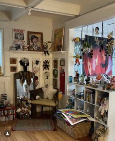 a living room filled with furniture and lots of clutter on the wall next to a window