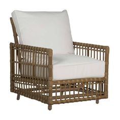 a wicker chair with white cushions on it