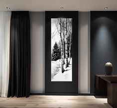 a black and white photo hanging on the wall next to a window with drapes