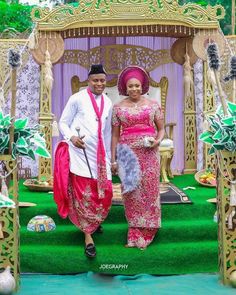 two people standing in front of a decorated stage