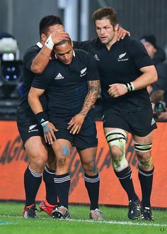 two rugby players are standing on the field