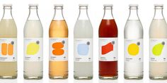 six different types of sodas in glass bottles with labels on each bottle and the same color