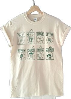 Organic Short Sleeve T-shirt For Spring, Organic White Short Sleeve Tops, Green Cotton T-shirt With Plant Print, Casual Cotton Shirt For Gardening, Organic Cotton Crew Neck Tops, Green T-shirt With Plant Print For Gardening, Organic Short Sleeve T-shirt With Screen Print, Relaxed Fit Shirt With Graphic Print For Gardening, Relaxed Fit Graphic Print Shirt For Gardening