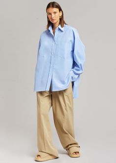 Color: White/Light Blue Lightweight shirting fabric Oversized fit Pointed collar Single breast pocket High-low curved hem Button front closure 100% Cotton Dry Clean By The Frankie Shop. Imported Product Measurements: XS/S - 24" Shoulder, 56" Bust, 31" Length M/L - 25" Shoulder, 59" Bust, 31.5" Length Model is 174cm/ 5'8" wearing size M/L Denim Projects, Shirting Fabric, The Frankie Shop, Frankie Shop, Stripe Shirt, Work Wear Women, Cut Shirts, Bra Women, Striped Shirt