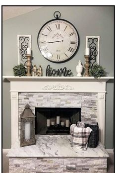 a fireplace with a clock above it and some candles on the mantels next to it