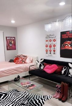 a black and white zebra print rug in a room with a bed, couch, and chandelier