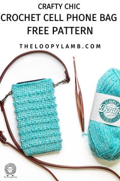 the crochet cell phone bag is next to a knitting needle and yarn ball