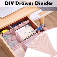 the drawer divider is open with scissors and other items in it on top of a wooden table