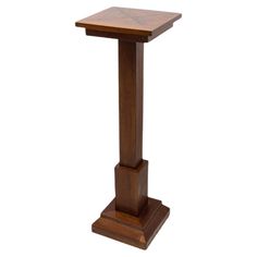 a wooden pedestal with a square top on it