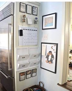 a refrigerator with magnets and pictures on the wall