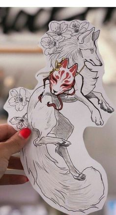 a person holding up a sticker with an image of a horse on it's back