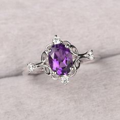 ◆ The ring is handcrafted from sterling silver and decorated with a dazzling 8*6 mm amethyst and CZs. It is suitable for engagement/anniversary/daily occasion. ◆ Production Description: Main stone Type: Natural Amethyst Main Stone Shape: Oval Cut Main Stone Size: 8*6 mm(1.14ct) Side stone: CZ  Metal: 925 Sterling silver - Other options available in the drop down menu ◆ Customization: √Free for Add Engraving  √Other Metal Type Available √Other Gemstones & Shapes Available  √Personalization Reques Luxury Vintage Amethyst Ring For Anniversary, Silver Oval Amethyst Ring With Gemstone Accents, Oval Silver Amethyst Ring With Gemstone Accents, Oval Amethyst Jewelry With Diamond Accents, Oval Amethyst Ring With Diamond Accents For Anniversary, Elegant Purple Birthstone Ring With Gemstone Accents, Anniversary Oval Amethyst Ring With Diamond Accents, Amethyst Rings With Diamond Accents, Oval Shape, Oval Purple Amethyst Ring With Gemstone Accents