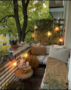 a balcony with lots of pillows and candles