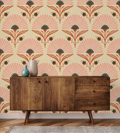 a sideboard with two vases on it in front of a wallpapered background