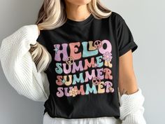 Welcome the sunny days in style with our 'Hello Summer' T-shirt! This vibrant and playful design features whimsical lettering in pastel shades, adorned with peace symbols and delicate flowers, capturing the essence of summer fun. Perfect for both daily wear and special summer outings, this graphic tee is crafted from soft, breathable fabric to keep you cool and comfortable. Whether you're hitting the beach or chilling in the park, this shirt is sure to add a touch of retro charm to your wardrobe. Product Features: Fabrication: Medium fabric (6.1 oz/yd² (206.8 g/m. Garment-dyed fabric. 100% ring-spun cotton Fit: Relaxed fit Sizing: Unisex Sizing Label: Sewn-in twill label Whimsical Lettering, Peace Symbols, Peace Signs, Hello Summer, Retro Vibe, Peace Sign, Summer Tshirts, Playful Design, Summer Fun