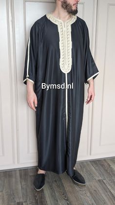 Are you ready to wear this stylish kandora with three-quarter sleeves during the celebration of Eid or during other occasions this coming summer? Or maybe just go to the mosque or visit family because it's possible? This beautiful traditional men's kandora is made of soft fabric (gabardine) and is embellished with delicate Arabic embroidery, giving it an elegant style. The soft fabric wraps smoothly around your body for freedom of movement, making you feel comfortable. Please note: The colors ma Black Kaftan For Eid And Traditional Ceremonies, Black Ceremonial Kaftan For Eid, Traditional Black Agbada For Ceremonies, Black Thobe For Eid And Traditional Ceremonies, Traditional Black Summer Kurta, Black Traditional Summer Kurta, Traditional Black Thobe For Eid, Black Embroidered Fabric For Eid Ceremonies, Elegant Black Agbada For Eid