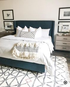 a bed with white linens and pillows in a small room next to pictures on the wall