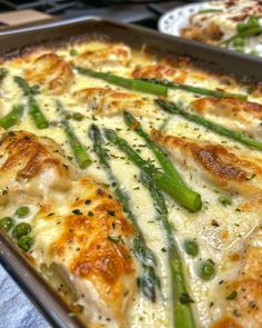 a casserole dish with asparagus and cheese