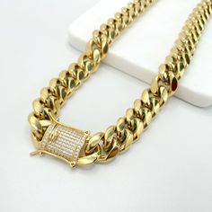 "A perfect gold chain made from 14k gold filled, available in 14mm and 10mm Miami Cuban chain style provides a large, fashionable look. Each piece comes with an iced double safety lock box clasp. Choose your size and feel the vibe. - Available Sizes: - Chain 10mm/16 Inches Long - Chain 10mm/18 Inches Long - Chain 10mm/24 Inches Long - Chain 14mm/18 Inches Long - Chaim 14mm/24 Inches Long - Chain 14mm/26 Inches Long - Chain 14mm/28 Inches Long - Chaim 14mm/30 Inches Long 💎 With new products dail Cuban Link Cubic Zirconia Chain Necklace Gift, Gold Cuban Link Necklace Gift, Gift Cuban Link Chain Necklace With Cubic Zirconia, Gold Link Necklace With Cubic Zirconia, Gold Cuban Link Necklace As Gift, Gold Cubic Zirconia Jewelry With Box Chain, Yellow Gold Curb Chain Necklace With Cubic Zirconia, Tarnish Resistant Cuban Link Necklace Gift, Gold Cuban Link Necklace In 14k Gold