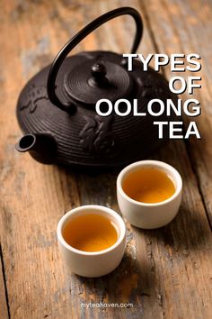 two cups of oolong tea sitting on top of a wooden table