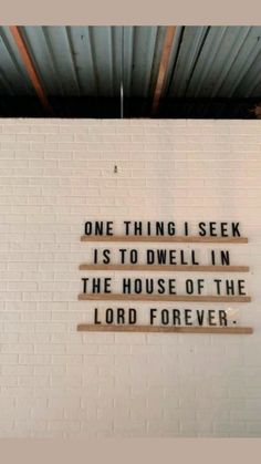 a brick wall that has some type of sign on it with the words, one thing i seek is to dwell in the house of the lord forever