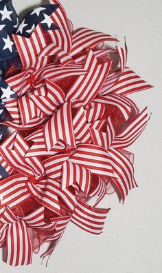 a bunch of red, white and blue bows with american flags on them sitting in a pile