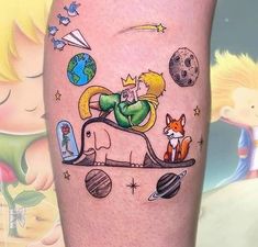 a small tattoo on the leg of a person with an animal and space theme in it