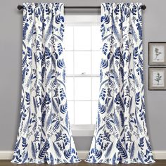 blue and white curtains hanging in front of a window