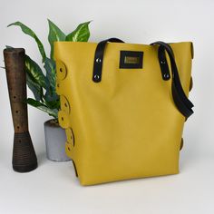 What a gorgeous mustard yellow purse/tote bag! This purse is made with 100% leather and is put together totally with rivets. The black straps are also oil tanned leather. The inside is not lined and that gives this tote that really cool look. Very roomy! The bottom of the purse has metal purse feet. Also, available in a light-colored leather with ostrich print. Size: 13” tall x 13” wide x 5” deep [33cm x 33cm x 13cm] Colors on the screen are as true as possible. Please realize that all monitors Trendy Tote Shoulder Bag With Gunmetal Hardware, Trendy Gold Leather Bucket Bag, Yellow Bags With Leather Handles For On-the-go, Trendy Yellow Bucket Bag For Everyday, Trendy Leather Satchel With Snap Closure, Trendy Yellow Everyday Bucket Bag, Everyday Gold Bags With Snap Closure, Chic Yellow Bags With Leather Lining, Trendy Mustard Shoulder Bag