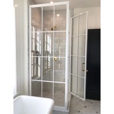 a white bath tub sitting next to a walk in shower