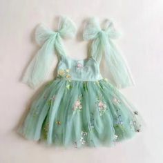 Make your little one feel like a princess with our enchanting tulle dress featuring delicate floral embroidery. This dress is adorned with large bows on the shoulder and around the waist, adding a touch of style and allowing for easy customization. It's the perfect attire for any special occasion, a thoughtful gift, or simply for playing dress-up! To ensure the best fit, we've sized this dress based on average toddler height within the following age groups: 1 Y - 80cm / 31.5-inch toddler 2 Y - 9 Fourest Birthday, Green Tulle Dress, Fairy 1st Birthday, Fairy Princess Dress, Tinkerbell Birthday, Fairy Garden Birthday, Floral Tulle Dress, Fairy Garden Birthday Party