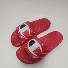 Elevate Your Kid's Casual Look With These Vibrant Red Champion Ipo Repeat Slide Sandals. These Unisex Sandals Are Perfect For Travel, Activewear, And Casual Occasions. They Are Made Of A Comfortable Synthetic Upper Material With A Blended Fabric Lining. The Sandals Feature A Low-Top Shoe Shaft, Standard Shoe Width, And Minimal Cushioning Level. The Rubber Cleat Type And Slip-On Style Make It Easy To Wear And Take Off. These Sandals Are Perfect For Summer, Fall, And Spring Seasons. Buy Them Now A Red Flat Sandals With Rubber Sole, Red Adjustable Comfortable Sandals, Comfortable Red Adjustable Sandals, Comfortable Adjustable Red Sandals, Red Synthetic Slippers, Red Slides With Cushioned Footbed For Beach, Red Cushioned Slides For The Beach, Trendy Adjustable Red Sandals, Red Cushioned Slides For Beach