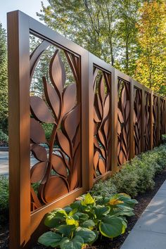 a wooden fence with metal panels and plants in the foreground on a sunny day