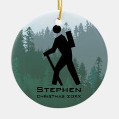 a christmas ornament with a silhouette of a hiker carrying a backpack in the woods