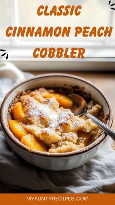 a close up of a bowl of food on a table with the words classic cinnamon peach cobbler