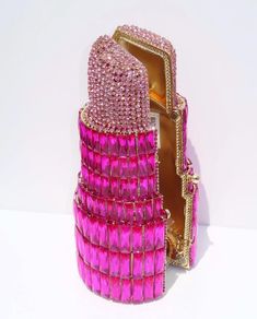 Take this pink lipstick clutch to your next event! Shaped like a lipstick, this unique evening bag is adorned with sparkling crystals that catch the light from every angle. Perfect for fashion-forward individuals, this luxury crystal purse is ideal for weddings, parties, or red carpet events. This eye-catching handbag is compact yet spacious enough to hold your essentials, including wallet, makeup, and credit cards. The secure clasp ensures your items stay safe while you dance the night away in style. Whether you're looking for a standout piece for a special occasion or a gift for a fashion lover, this rhinestone clutch is sure to impress. Get ready to turn heads with this one-of-a-kind accessory! Please visit our website  www.emilianocltuch.com for catalog Product Details: MUST MESSAGE BE Pink Crystal Embellished Evening Bag For Formal Events, Pink Crystal Embellished Evening Bag For Formal Occasions, Pink Crystal Embellished Party Evening Bag, Luxury Pink Rhinestone Evening Bag, Luxury Pink Evening Bag With Rhinestones, Pink Rhinestone Clutch For Events, Pink Rhinestone Clutch For Evening, Pink Rhinestone Evening Bag For Parties, Luxury Pink Handheld Evening Bag