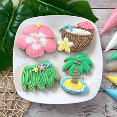 decorated cookies on a plate with tropical decorations