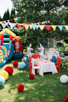 an inflatable bouncer and table set up for a birthday party with decorations