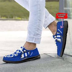 a person wearing blue shoes and white pants standing next to a glass door with the words custom name on it