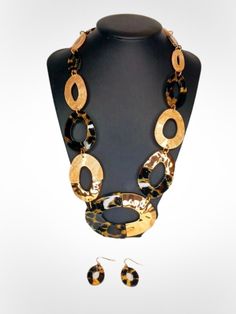 Deck yourself in the timeless sophistication of our "Leopard" Necklace and Earrings Set. Made with graduated organic marbled light brown acetate links and acetate leopard links, detailed with gold metal, this set exudes elegant charm. Bring out your wild side and elevate any outfit with this versatile piece. Chic Leopard Print Jewelry, Trendy Adjustable Tortoiseshell Jewelry, Trendy Brown Chain Jewelry, Elegant Adjustable Tortoiseshell Jewelry, Trendy Tortoiseshell Jewelry For Gifts, Trendy Tortoiseshell Jewelry Gift, Modern Brown Jewelry For Parties, Chic Brown Round Jewelry, Chic Tortoiseshell Jewelry For Gifts