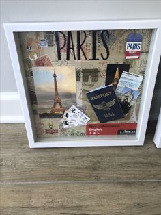 a collage of travel related items is displayed in a white frame on the floor