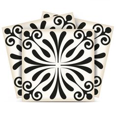 three black and white coasters with swirl designs on the top, one has a square shape